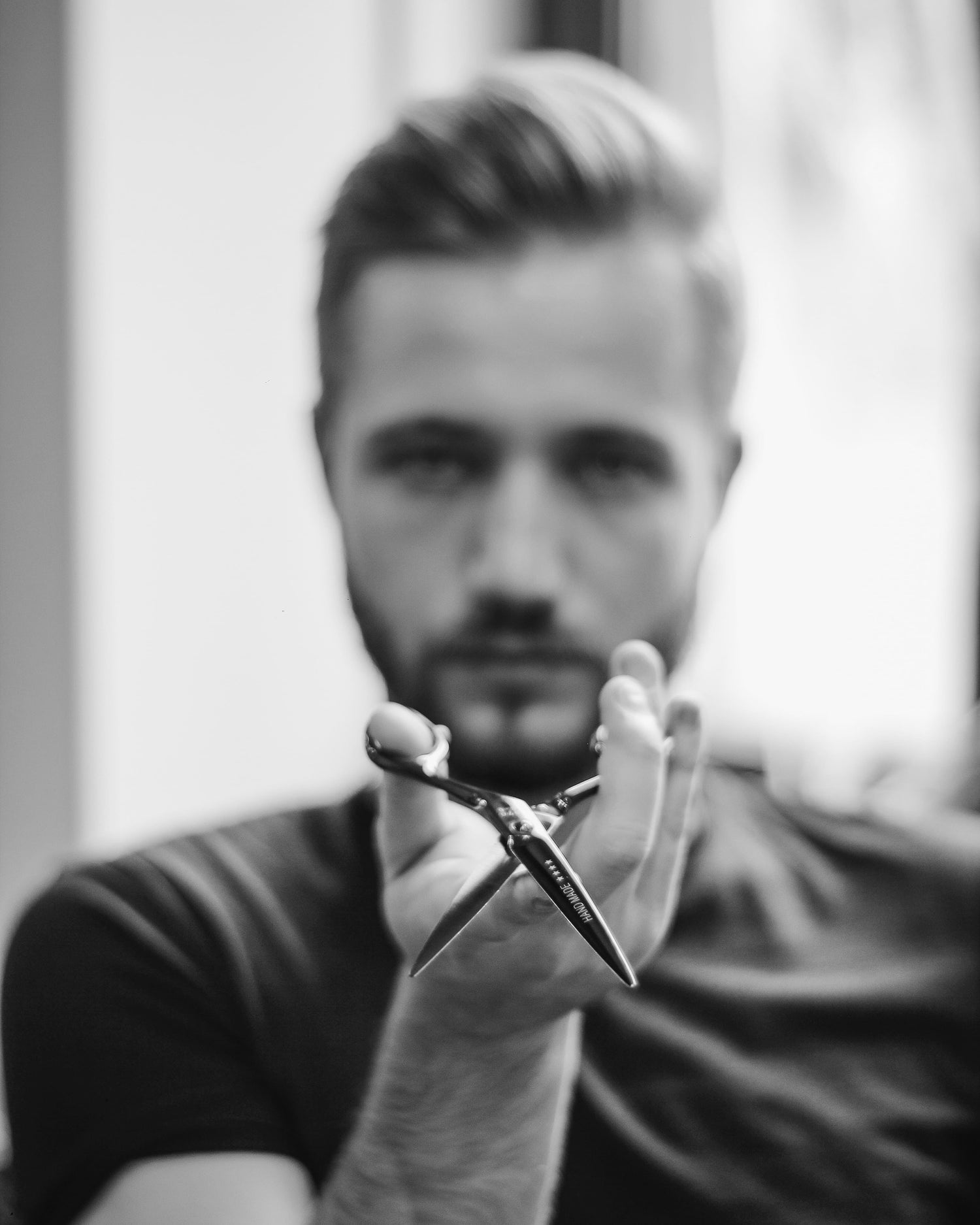 A hairdresses pointing scissors towards the camera. Concept of hair loss.